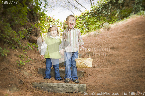 Image of Two Children Walking Down Wood Steps with Basket Outside.