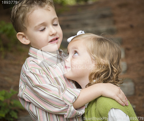 Image of Adorable Brother and Sister Children Hugging Outside
