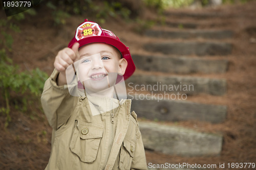 Image of Adorable Child Boy with Fireman Hat Playing Outside