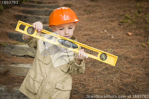 Image of Adorable Child Boy with Level Playing Handyman Outside