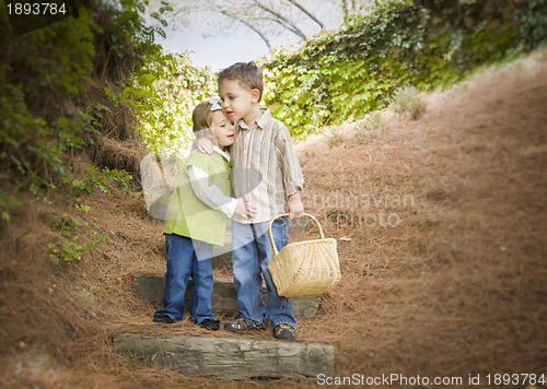 Image of Two Children with Basket Hugging Outside on Steps
