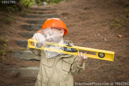 Image of Adorable Child Boy with Level Playing Handyman Outside