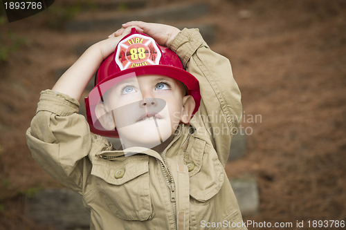 Image of Adorable Child Boy with Fireman Hat Playing Outside