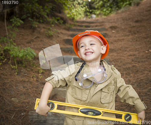 Image of Adorable Child Boy with Level Playing Handyman Outside