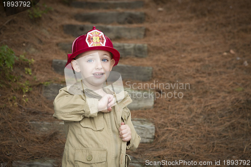 Image of Adorable Child Boy with Fireman Hat Playing Outside