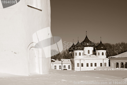 Image of christian orthodox male priory amongst snow, sepia