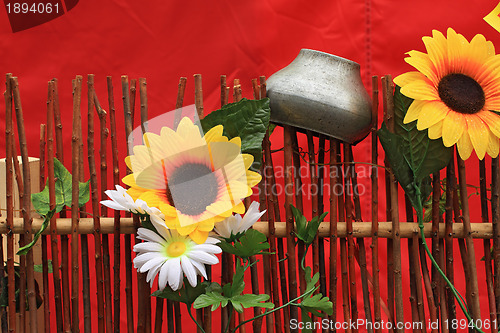 Image of old pitcher on wooden fence