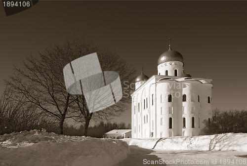 Image of christian orthodox male priory amongst snow, sepia