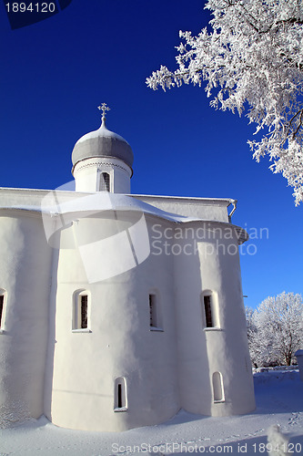 Image of tree in snow against christian church 