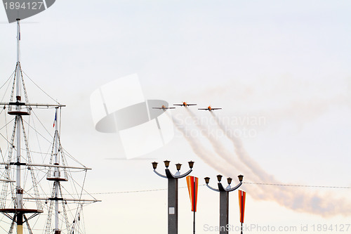 Image of three small planes in cloudy sky