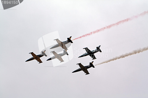 Image of four jet planes in cloudy sky