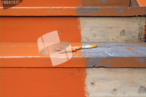 Image of dirty brush in red paint