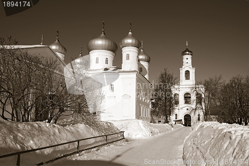 Image of christian orthodox male priory amongst snow, sepia