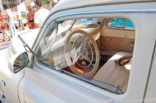 Image of old car on town street