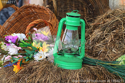 Image of aging kerosine lamp in hay