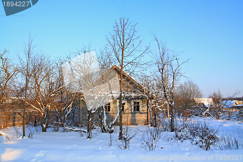 Image of old rural house amongst snow