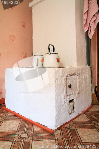 Image of brick stove in rural wooden house 