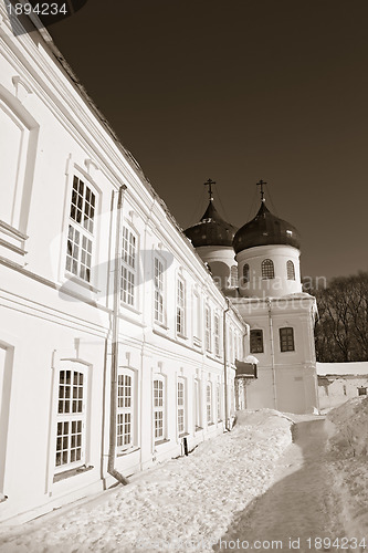 Image of christian orthodox male priory amongst snow, sepia