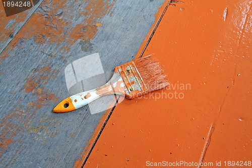 Image of dirty brush in red paint