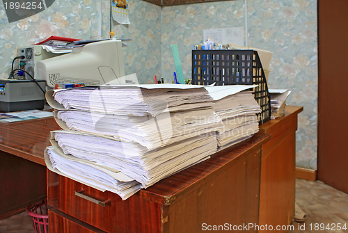 Image of heap of the papers on table in office