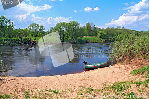 Image of motor boat on river coast 