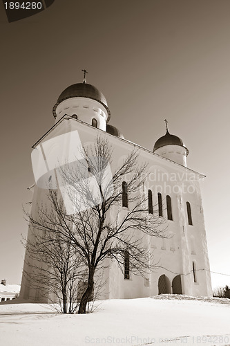 Image of christian orthodox male priory amongst snow, sepia