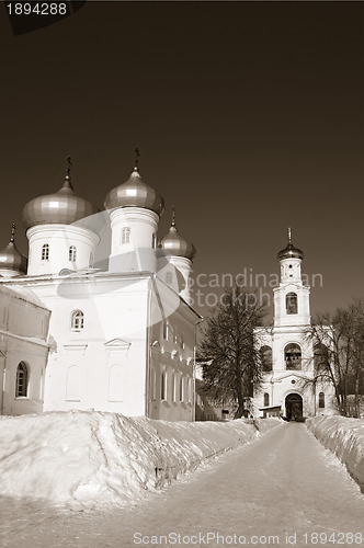 Image of christian orthodox male priory amongst snow, sepia