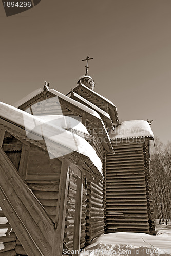 Image of wooden chapel on blue background, sepia