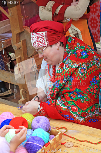 Image of woman is in national cloth to sew