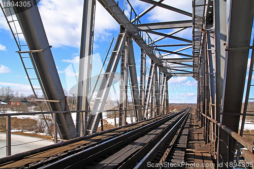 Image of railway bridge through freeze river 