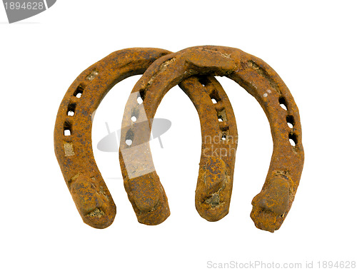 Image of Retro rusty pair of horseshoes isolated on white 