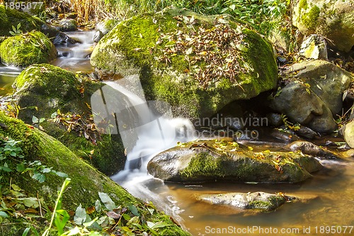 Image of Falls on the small mountain river in a wood shooted in autumn