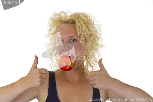 Image of Beautiful woman biting into a red juicy apple