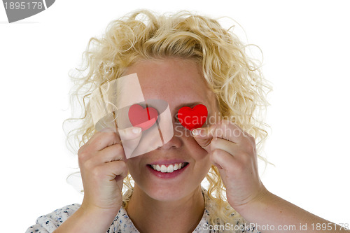 Image of Young woman hiding her eyes with texture hearts