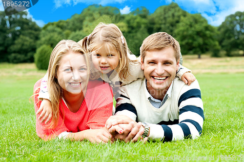 Image of Happy young family with daughter outdoors