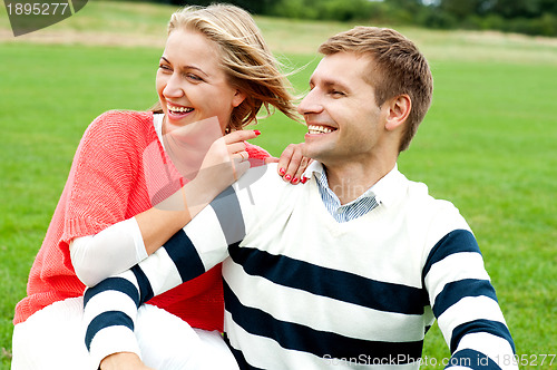 Image of Woman pointing at her lovable husband