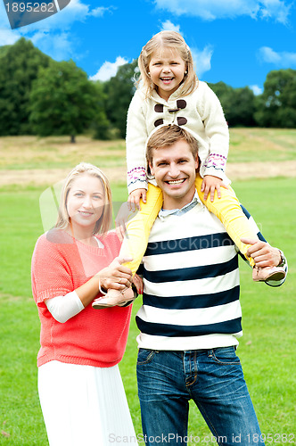 Image of Pretty daughter enjoying day out with parents