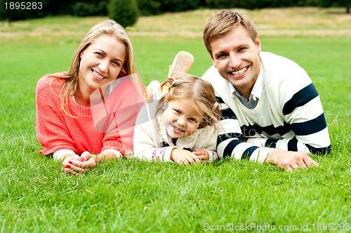 Image of Young family of three spending a happy day outdoors