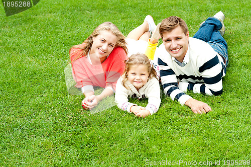 Image of Laughing family of three having fun together