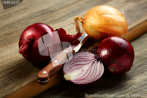 Image of Knife,red onion and a half.