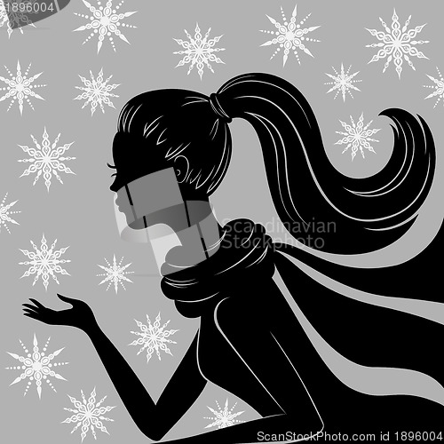 Image of Silhouette of young woman with flying snowflakes