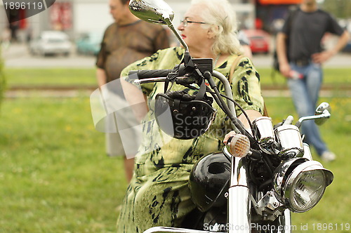 Image of woman and a motorcycle