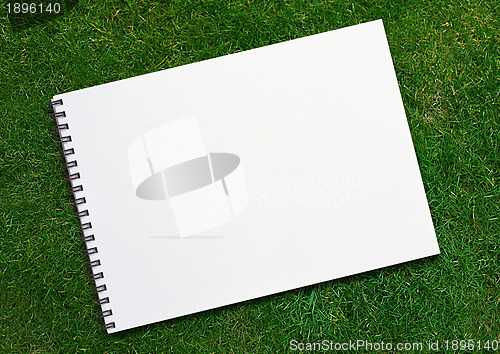 Image of  notebook on grassland