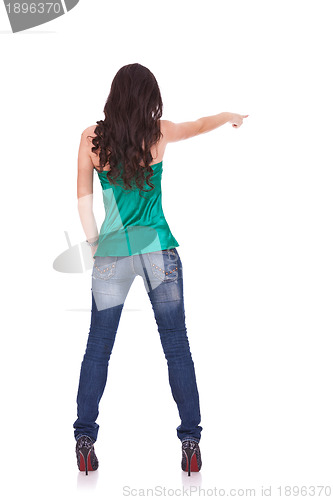 Image of young casual woman points finger