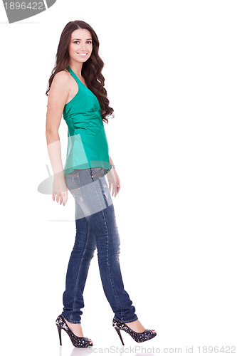 Image of side view of a young casual woman walking