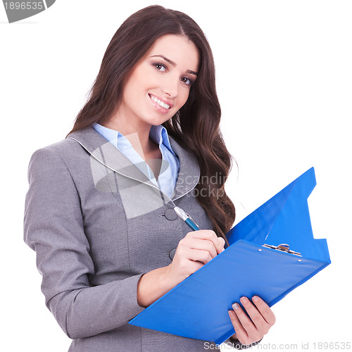 Image of business woman writing on clipboard