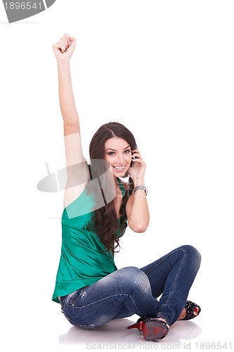 Image of casual girl cheering during phone call