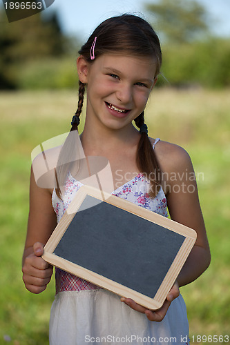 Image of Young girl holding a small blackboard