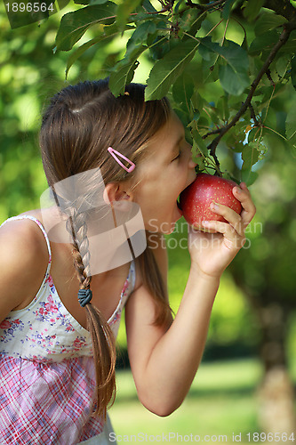Image of Girl biting into an apple
