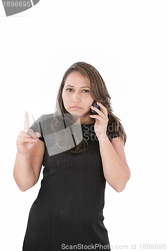 Image of a woman with a serious expression on her face holding her phone 